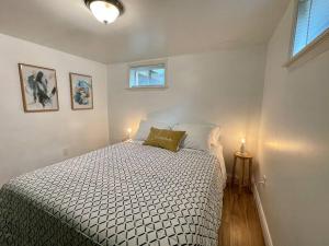 a bedroom with a bed and two lamps and a window at Upscale, Brand New, Full Kitchen, 2-Bedroom Apt in Falls Church
