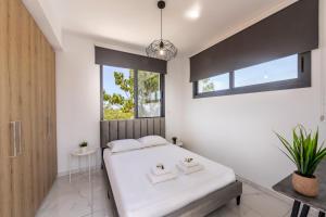 a bedroom with a white bed and a window at Alasia Villas in Paralimni +96 photos