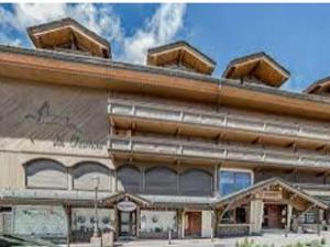 a large building with a painting on the side of it at Appartement Courchevel 1850, 3 pièces, 6 personnes - FR-1-564-80 in Courchevel