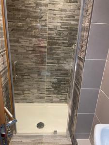 a shower with a glass door in a bathroom at City Centre 1 Bed Sleeps 4 H5 in Hull