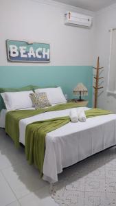 Postelja oz. postelje v sobi nastanitve Recanto da Orla - apartamento lindo e aconchegante - 2 Quartos