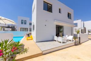 a bedroom villa with a swimming pool at Alasia Villas in Paralimni