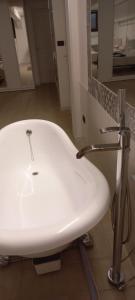 a bathroom with a white sink and a mirror at Le Due Palme House in Torre San Giovanni Ugento