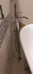 a bathroom with a white sink in a room at Le Due Palme House in Torre San Giovanni Ugento