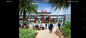 a group of people walking in front of a shopping center at Doncaster Westfield Home Stay in Doncaster