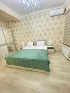 Ein Bett oder Betten in einem Zimmer der Unterkunft Samarkand Fruza гостевой дом