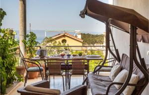 a patio with a table and chairs on a balcony at Nice Apartment In Makarska in Makarska +30 photos