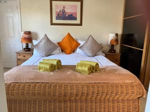a bedroom with a bed with two pillows on it at Hygge Somerset in Street