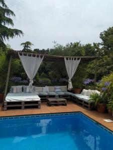 a backyard with a pool and a gazebo at El Atico de Villalmar in Tui