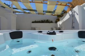 a large swimming pool with a large tub at 21mq Suite Home in Ostuni