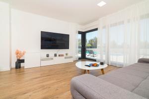 a living room with a couch and a table at Villa Abelia in Pirovac