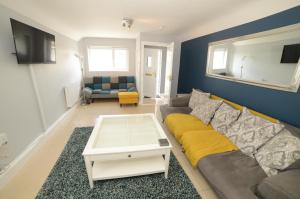 a living room with a couch and a table at Notting Hill West in the heart of Westport Town in Westport