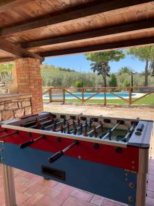 a large red and blue foosball table on a patio at L'Antico Casale in Bisacquino