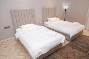 A bed or beds in a room at Termez Palace Hotel & Spa