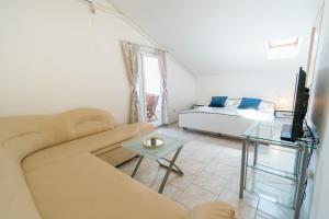 a living room with a couch and a table at Apartments Blažević in Pirovac