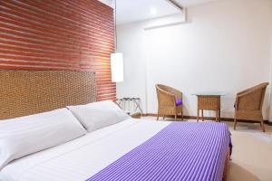 Ένα ή περισσότερα κρεβάτια σε δωμάτιο στο Hotel Santorini Resort