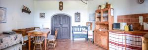 a kitchen with a table and a blue door at Máli Pince in Aszófő