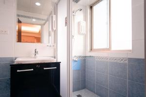 a bathroom with a sink and a shower at Kiwi Express Hotel - Kaohsiung Station in Kaohsiung +72 photos