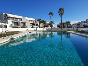 a large swimming pool in front of some buildings at Casa Pinto in Villacosta