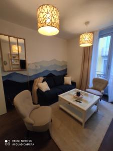 a living room with a couch and a coffee table at L'EDEN DU LYS in Cauterets