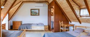 a bedroom with two beds in a attic at Máli Pince in Aszófő