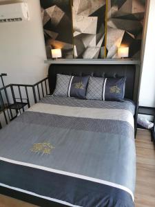 a bedroom with a large bed with two pillows at Villa46 in Pécs