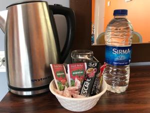 a counter with a container of food and a bottle of water at City House Hotel in Antalya