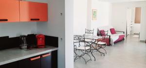 a kitchen and a living room with a table and chairs at Perle in Nice +14 photos
