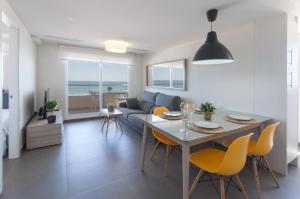 a dining room and living room with a table and chairs at AG Aquarium in Playa de Gandia