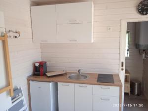 a kitchen with a sink and a counter top at Studio au fil de l'eau in Saulzoir