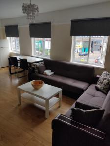 a living room with a couch and a table at Cheerful 3 Bedroom house just across tube station in London