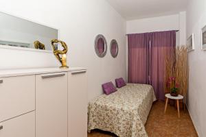 a small room with a bed and a purple curtain at Apartment Lima Prime Location Playa Blanca By PVL in Playa Blanca