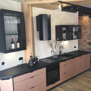 una cocina con encimera negra con botellas de vino en Bielsko Citylife Luxury Apartment en Bielsko-Biala