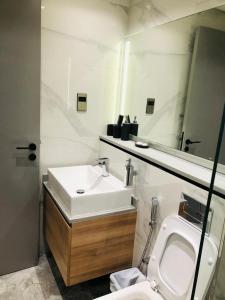 a bathroom with a sink and a toilet at MAG318 Residence -Stunning Canal View by Cozy Homes in Dubai
