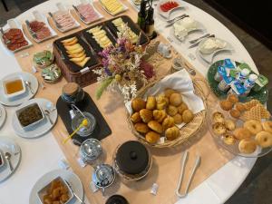 a table with plates of food on a table at Hotel da Vila in Manteigas