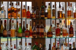 a display of different types of bottles of alcohol at Manoir de Lébioles in Spa