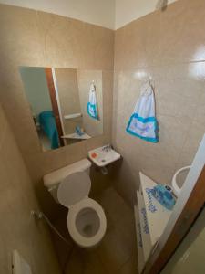 a small bathroom with a toilet and a sink at Leams in Playa Unión