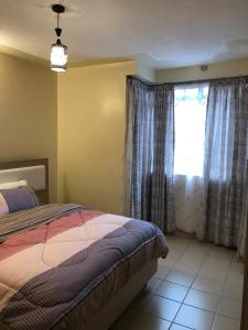 Postel nebo postele na pokoji v ubytování Maliaways Comfy Airbnb-Jkia