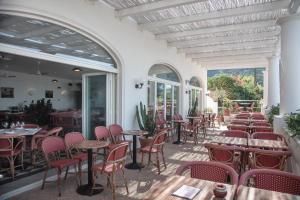 a patio with tables and chairs in a restaurant at Il Capri Hotel in Capri