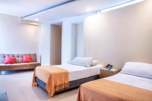 Ένα ή περισσότερα κρεβάτια σε δωμάτιο στο Hotel Santorini Resort