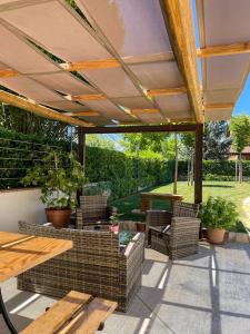 an outdoor patio with chairs and a wooden table at Casa Rurale Faraone in Teggiano
