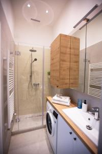 a bathroom with a washing machine and a shower at Friends Hostel & Apartments in Budapest