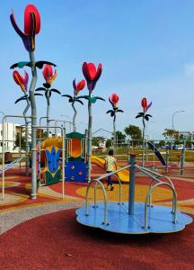 a child is playing in a playground at Spring Fields Homestay by Sizma in Semenyih