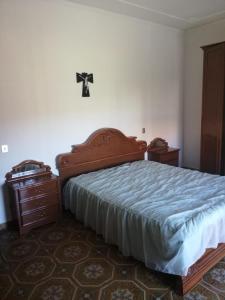 a bedroom with a large bed and a dresser at Casa Garri' Sciconi di Briatico in Briatico