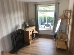 a living room with a radiator and a window at Honey lodge in Caeathro