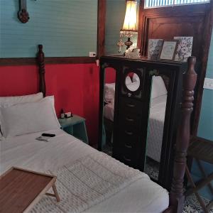 a bedroom with a bed and a dresser with a lamp at COZY NEST in Guayama