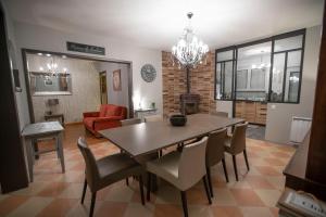 a dining room and living room with a table and chairs at Chambre de Charme dans maison d'hote "Le Petit Clouet" - Rochecorbon in Rochecorbon