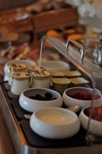 a tray filled with different types of food on a table at Le Rose Thé in La Ciotat