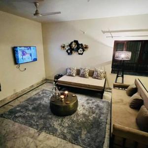 a living room with a couch and a table at Shivalaya cottage,Home away from home,mehragaon,bhimtal in Bhowāli