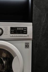 a washing machine with a tv on top of it at RentWill apartments Loft in Chişinău